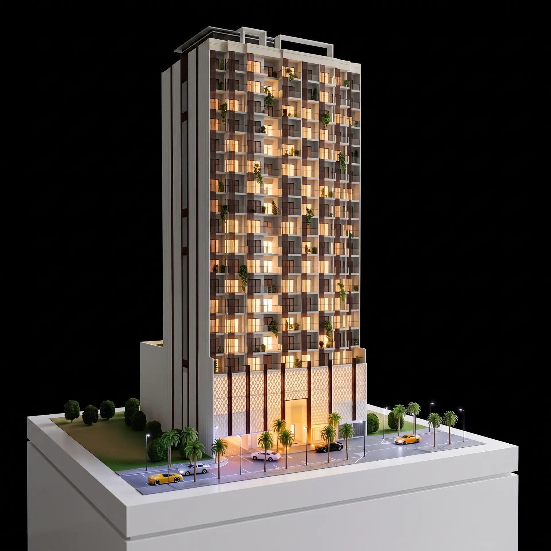 High-rise residential scale model with lit balconies on a white presentation base