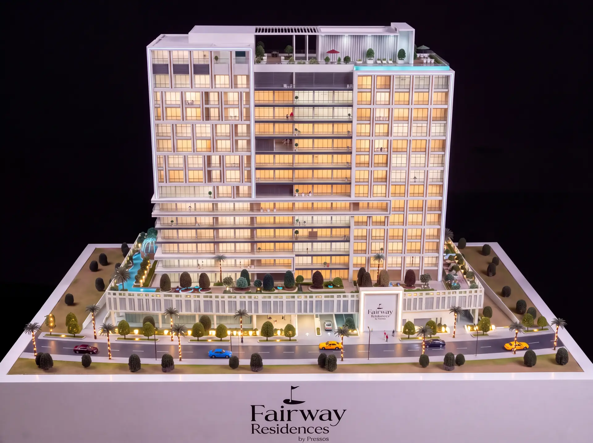 Fairway Residences scale model with landscaped amenity deck, pools and illuminated facade